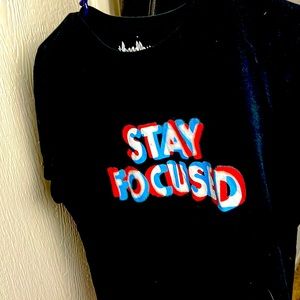 SIZE MEDIUM- Black shirt with words that say “Stay Focused” on the front.